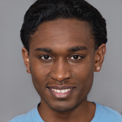 Joyful black young-adult male with short  brown hair and brown eyes