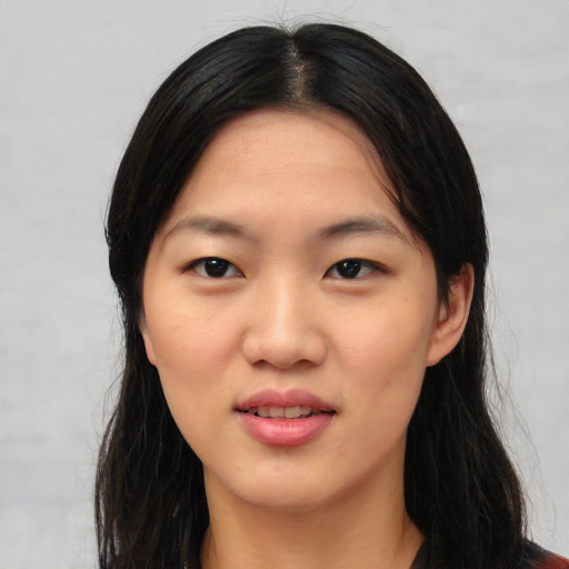Joyful asian young-adult female with long  black hair and brown eyes