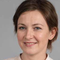 Joyful white adult female with medium  brown hair and brown eyes