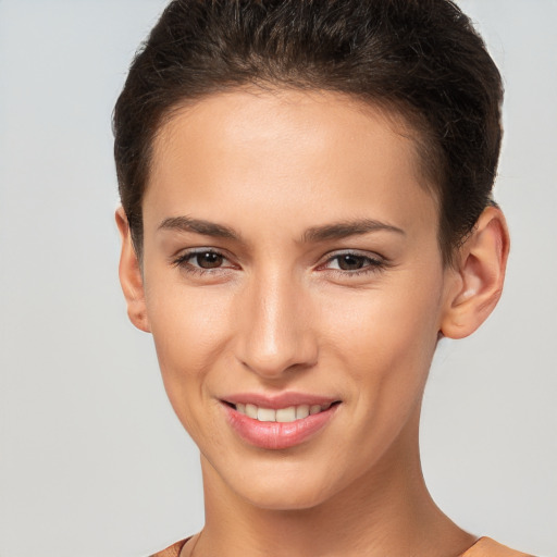 Joyful white young-adult female with short  brown hair and brown eyes