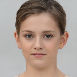 Joyful white child female with short  brown hair and grey eyes