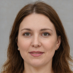 Joyful white adult female with long  brown hair and brown eyes