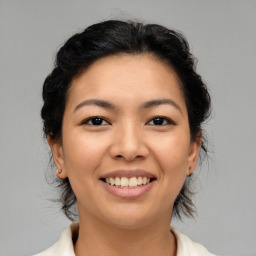 Joyful asian young-adult female with medium  brown hair and brown eyes