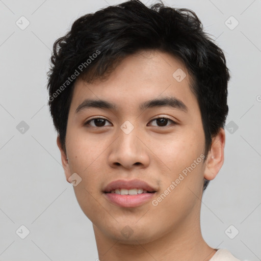 Joyful asian young-adult male with short  brown hair and brown eyes