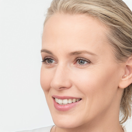 Joyful white young-adult female with medium  brown hair and blue eyes