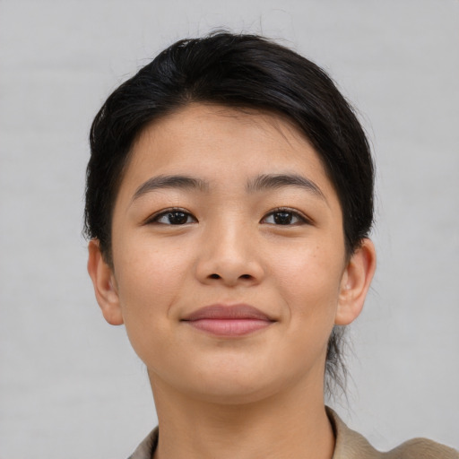 Joyful asian young-adult female with short  brown hair and brown eyes