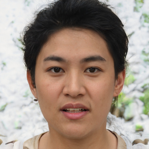 Joyful asian young-adult male with short  brown hair and brown eyes