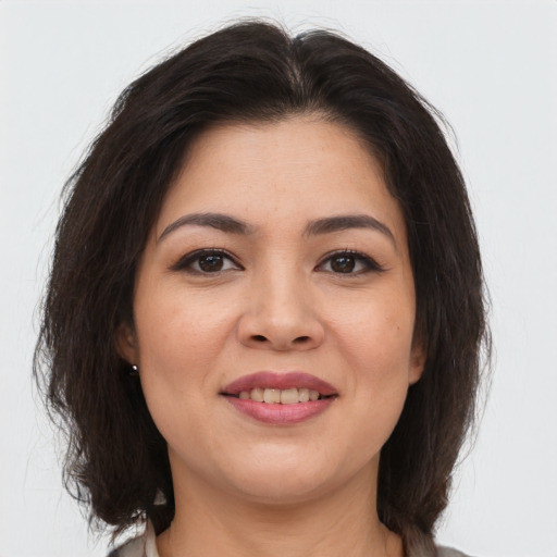 Joyful asian young-adult female with medium  brown hair and brown eyes