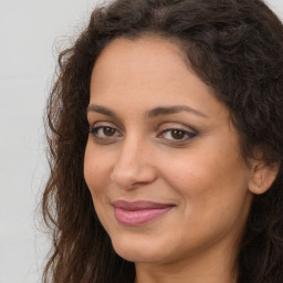 Joyful white adult female with long  brown hair and brown eyes