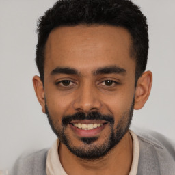 Joyful latino young-adult male with short  black hair and brown eyes