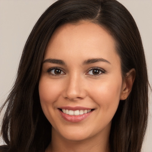 Joyful white young-adult female with long  brown hair and brown eyes