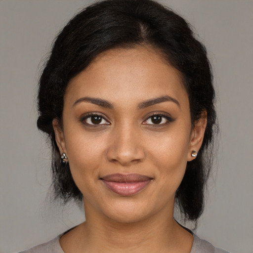 Joyful black young-adult female with medium  brown hair and brown eyes