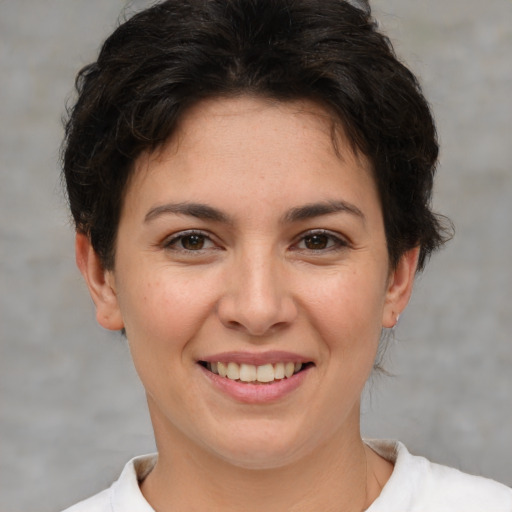 Joyful white young-adult female with short  brown hair and brown eyes