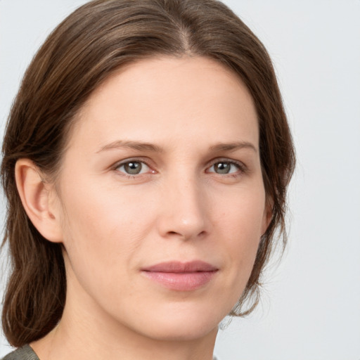 Joyful white young-adult female with medium  brown hair and green eyes