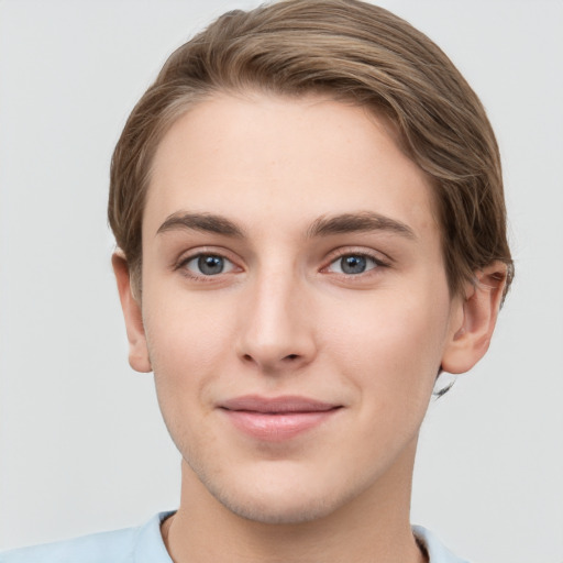 Joyful white young-adult female with short  brown hair and grey eyes