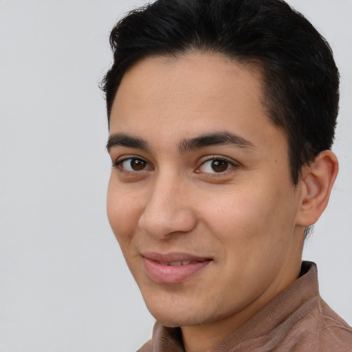 Joyful latino young-adult male with short  brown hair and brown eyes