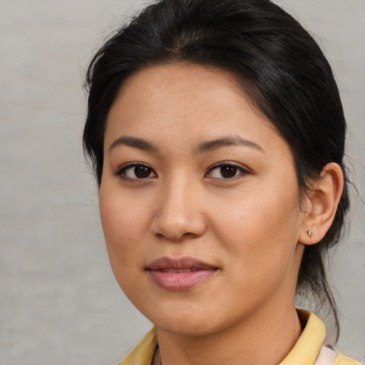 Joyful asian young-adult female with medium  brown hair and brown eyes