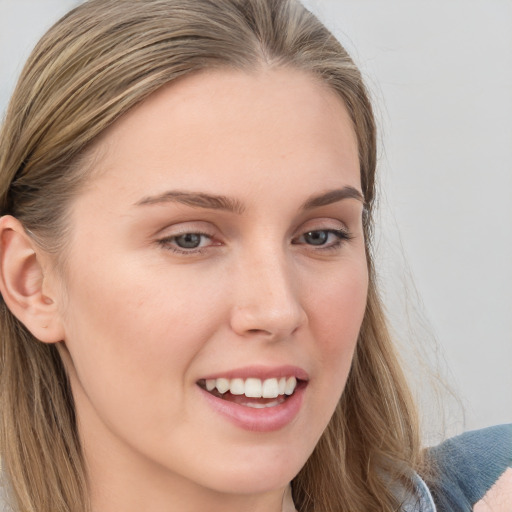 Joyful white young-adult female with long  brown hair and blue eyes