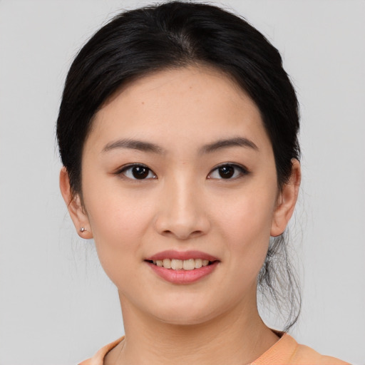 Joyful asian young-adult female with medium  black hair and brown eyes