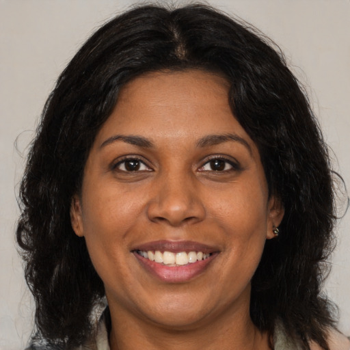 Joyful black young-adult female with medium  brown hair and brown eyes