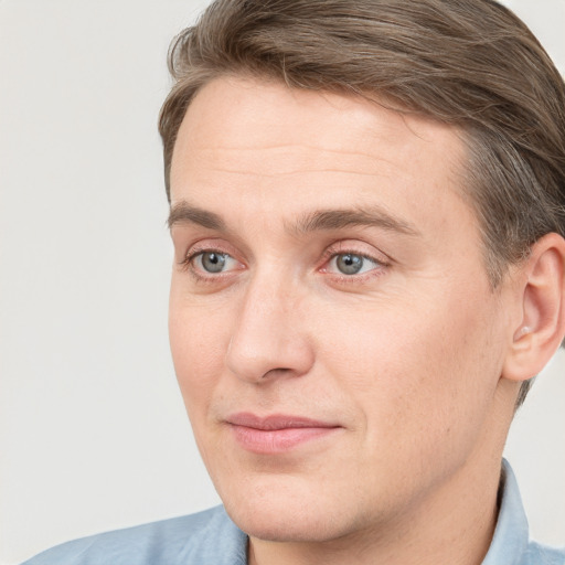 Joyful white adult male with short  brown hair and grey eyes