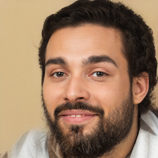 Joyful white young-adult male with short  black hair and brown eyes