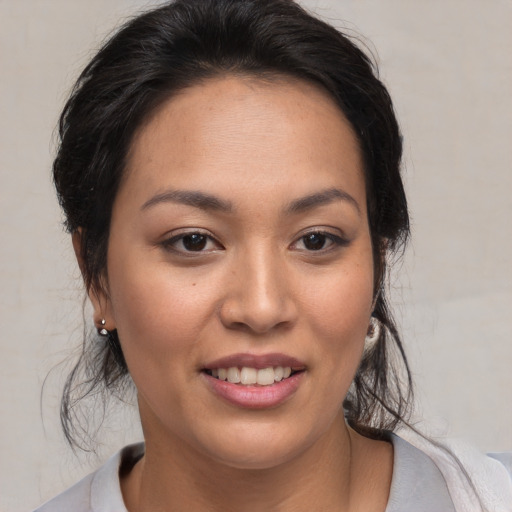 Joyful black young-adult female with medium  brown hair and brown eyes