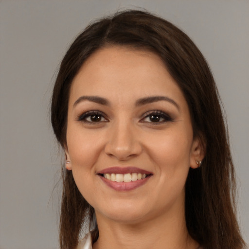 Joyful white young-adult female with long  brown hair and brown eyes