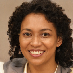 Joyful black adult female with short  brown hair and brown eyes