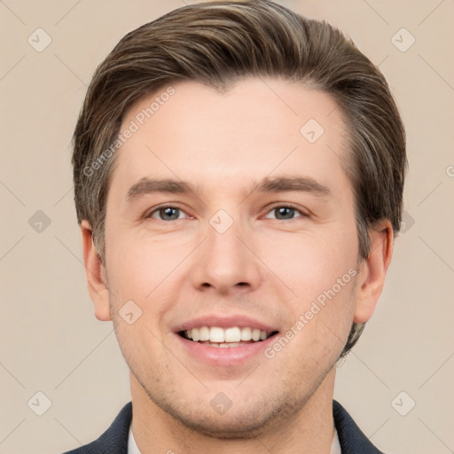 Joyful white young-adult male with short  brown hair and grey eyes