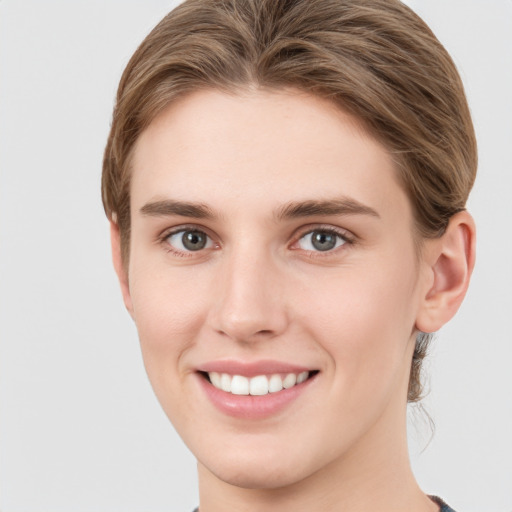 Joyful white young-adult female with short  brown hair and grey eyes