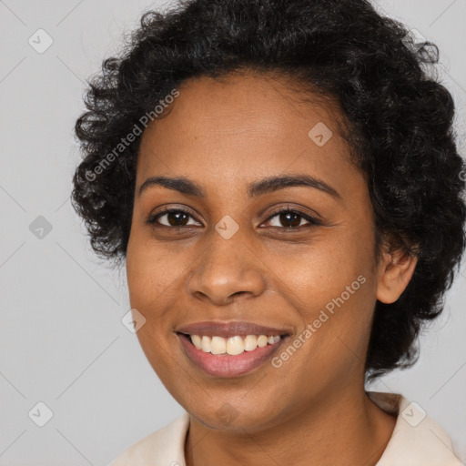 Joyful black young-adult female with long  brown hair and brown eyes