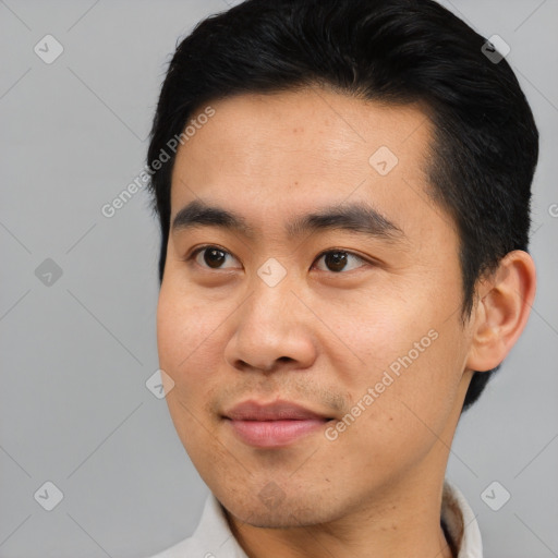 Joyful asian young-adult male with short  black hair and brown eyes