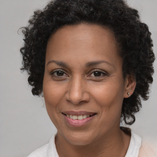 Joyful black adult female with short  brown hair and brown eyes