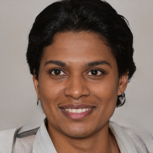 Joyful latino young-adult female with short  black hair and brown eyes