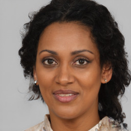 Joyful black adult female with medium  brown hair and brown eyes