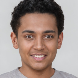 Joyful latino young-adult male with short  brown hair and brown eyes