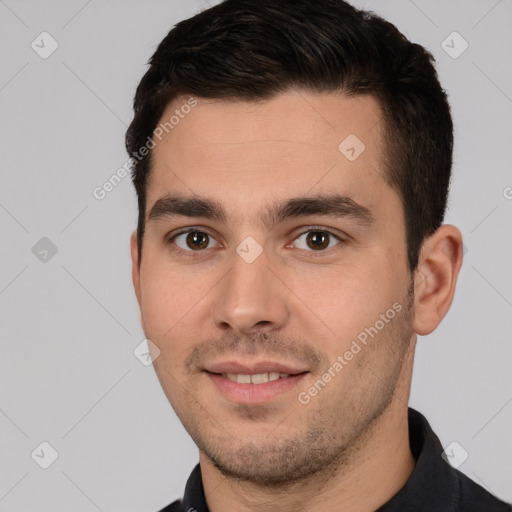 Joyful white young-adult male with short  brown hair and brown eyes