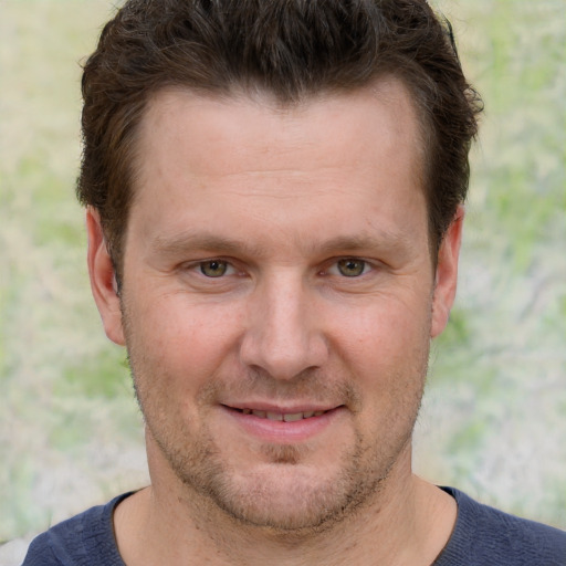 Joyful white adult male with short  brown hair and grey eyes