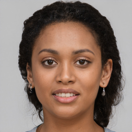 Joyful latino young-adult female with long  brown hair and brown eyes
