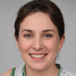 Joyful white adult female with medium  brown hair and grey eyes