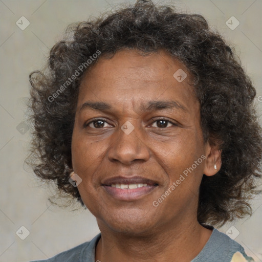 Joyful black adult female with medium  brown hair and brown eyes