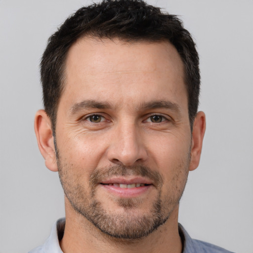 Joyful white adult male with short  brown hair and brown eyes