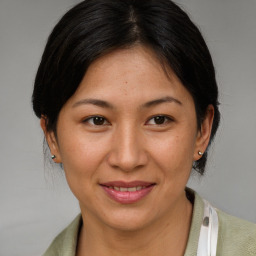 Joyful latino adult female with medium  brown hair and brown eyes