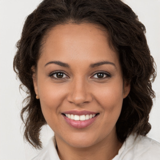 Joyful white young-adult female with long  brown hair and brown eyes