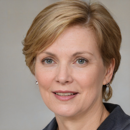 Joyful white adult female with medium  brown hair and blue eyes