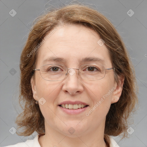 Joyful white adult female with medium  brown hair and blue eyes