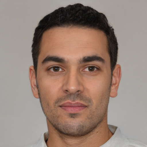 Neutral latino young-adult male with short  black hair and brown eyes