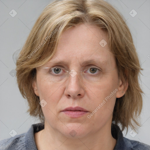 Joyful white adult female with medium  brown hair and blue eyes