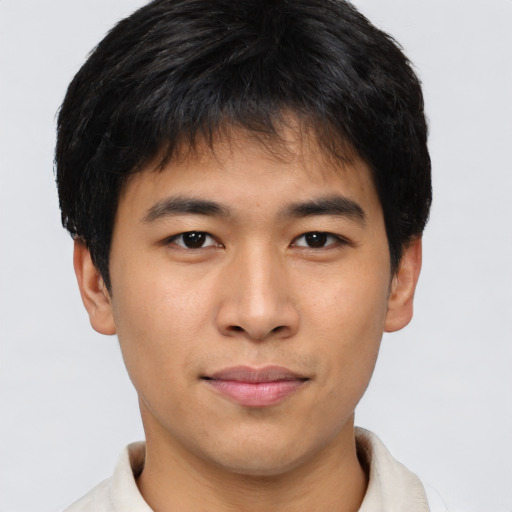 Joyful asian young-adult male with short  brown hair and brown eyes